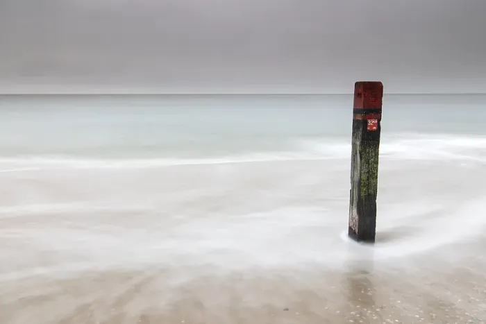 Framed Print : Landmark. Pole on the beach of Texel