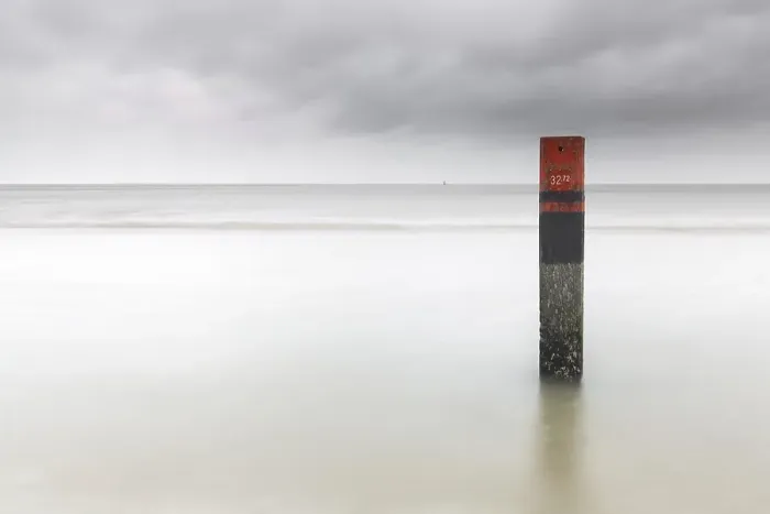 Framed Print : Landmark. Pole on the beach of Texel