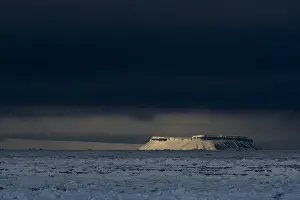 Norway Prints: A sunlit mountain emerges from the sea ice in the Erik Eriksenstretet